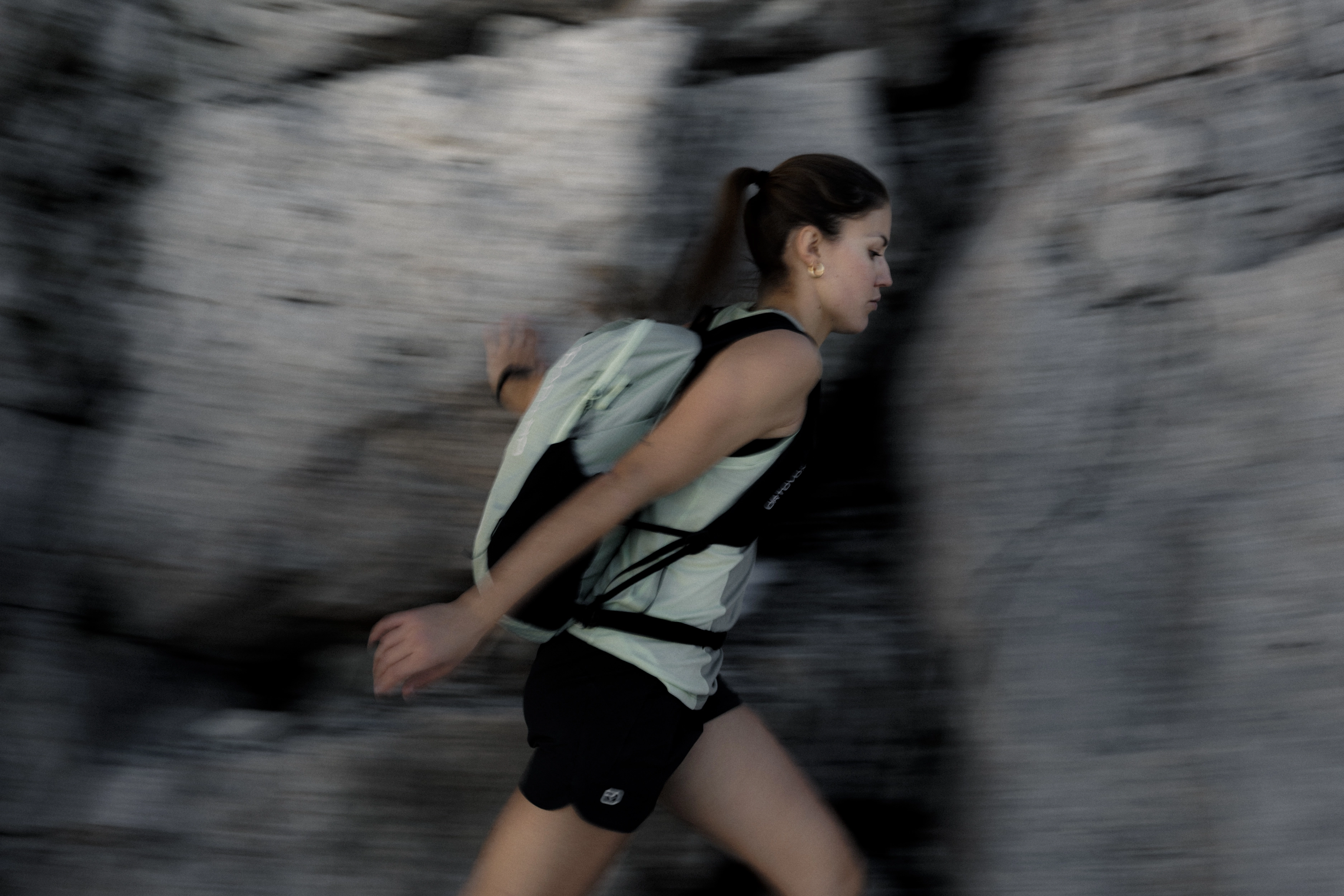 runner, backpack, tank top, shorts, motion blur