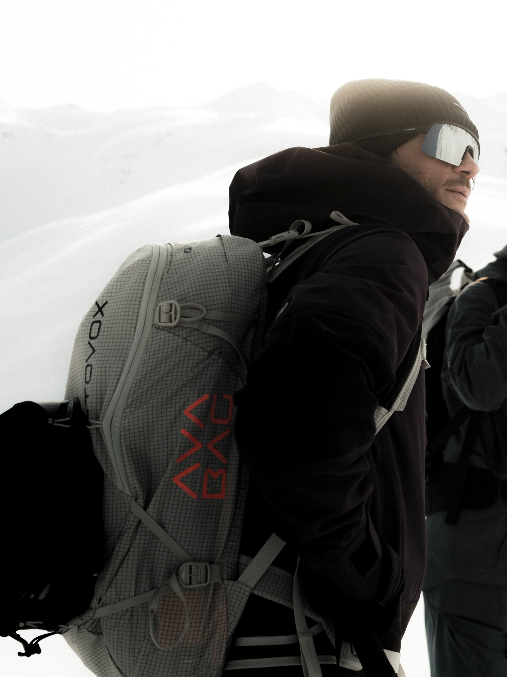 ski backpack, gray grid pattern, technical fabric, red logo, adjustable straps