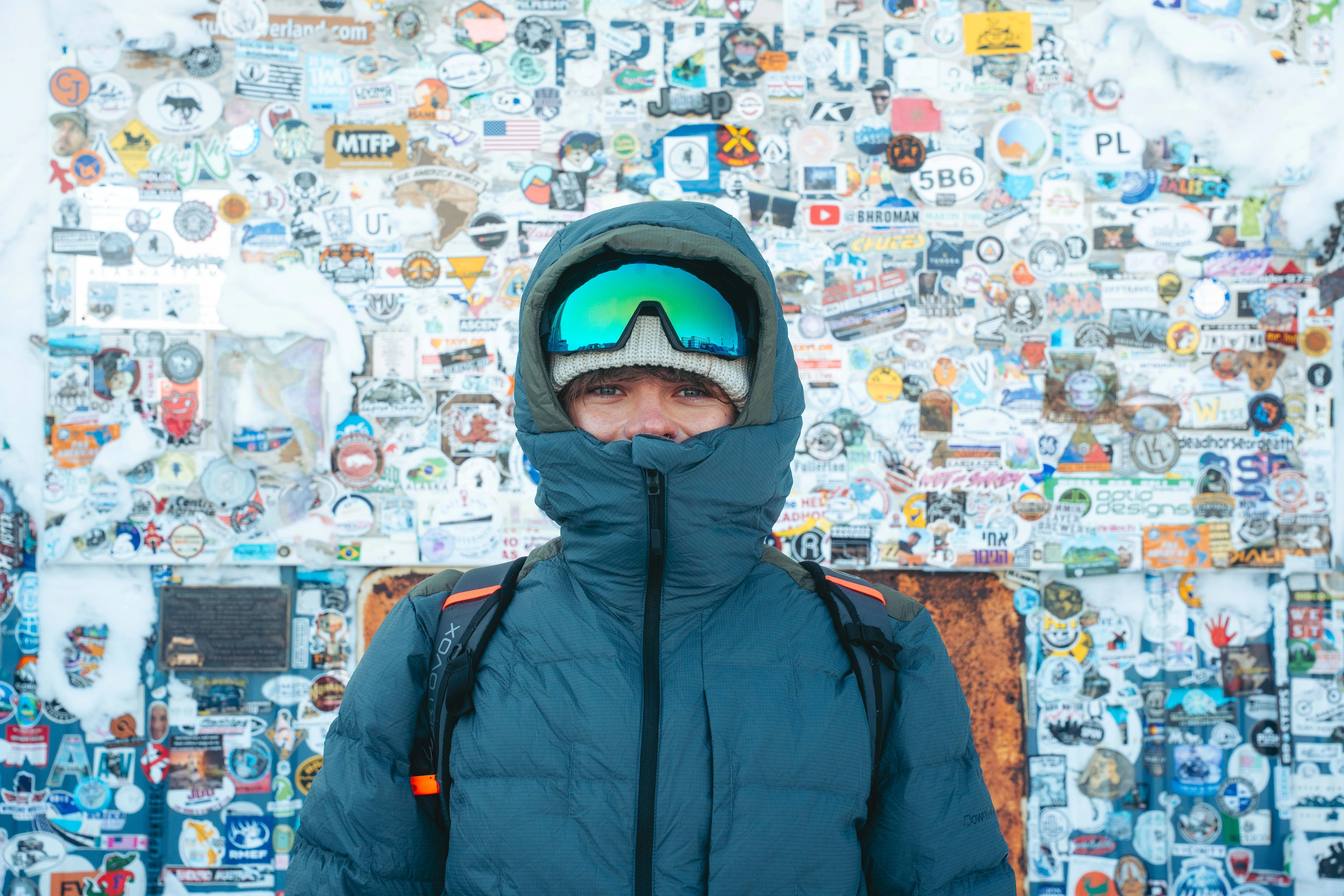winter jacket, puffer coat, hooded jacket, ski goggles, snowy background