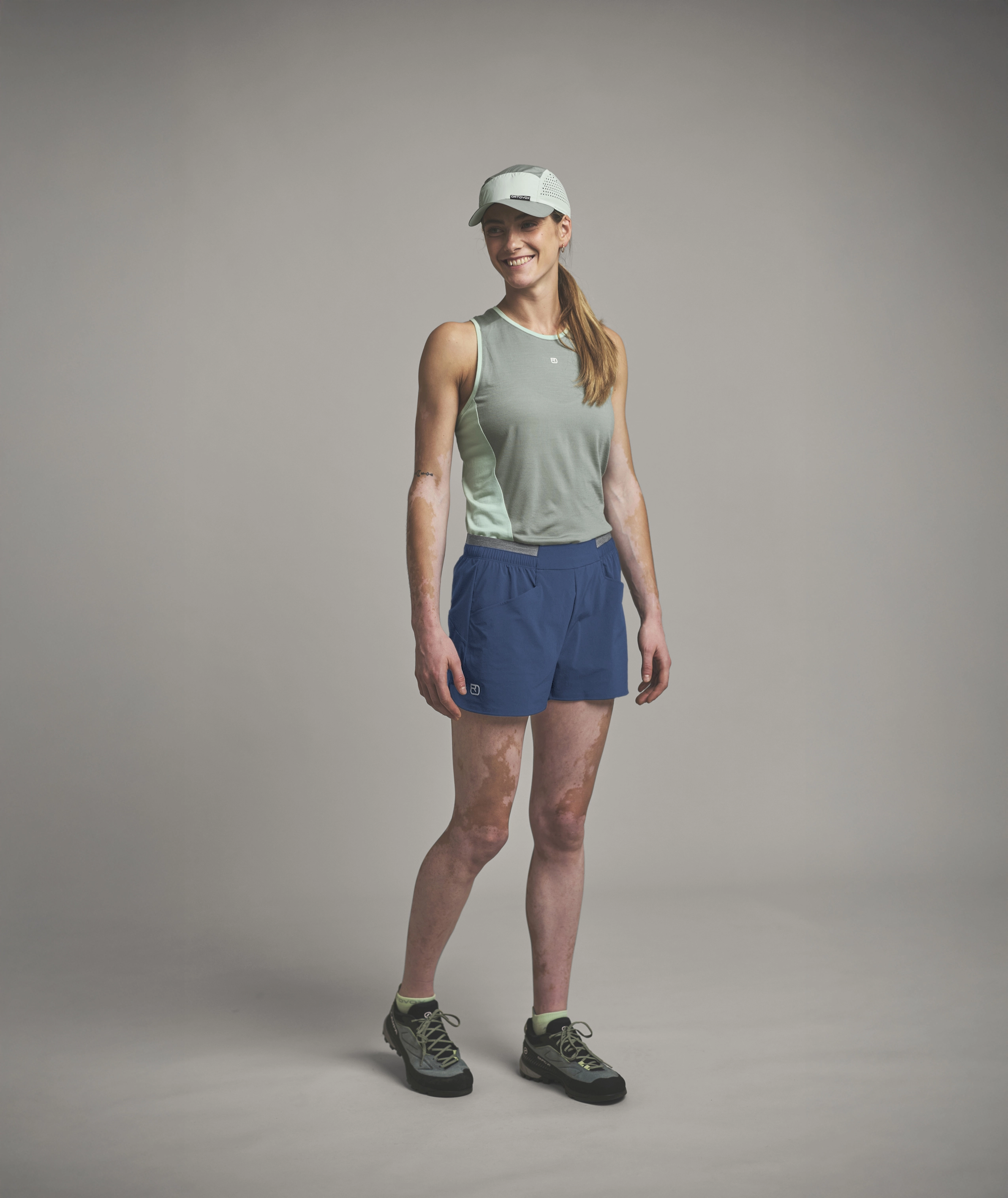 athlete, tank top, shorts, cap, trail running