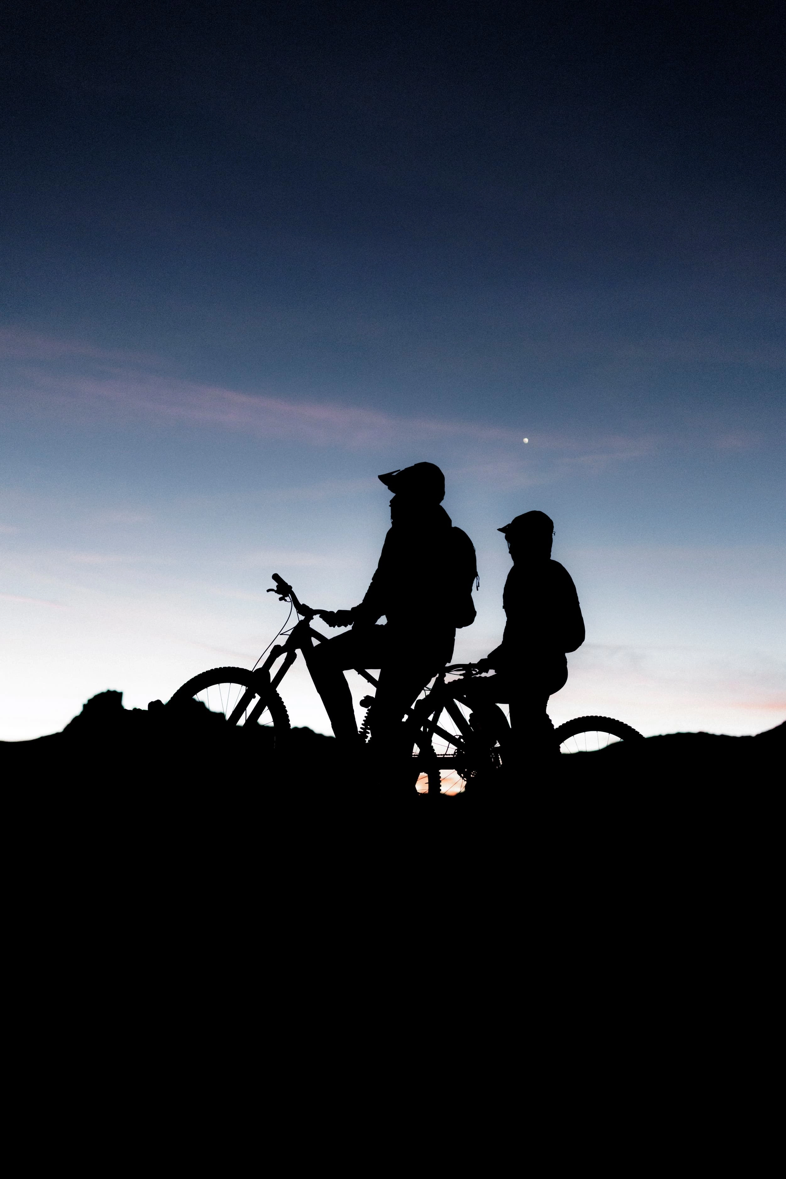 silhouette, bikes, mountain, riders, dark, bicycle, silhouette, two people, outdoor, sunset, bicycle, silhouette, pedestrians, mountain, outdoors, bicycle, mountain bike, silhouette, two people, sunset